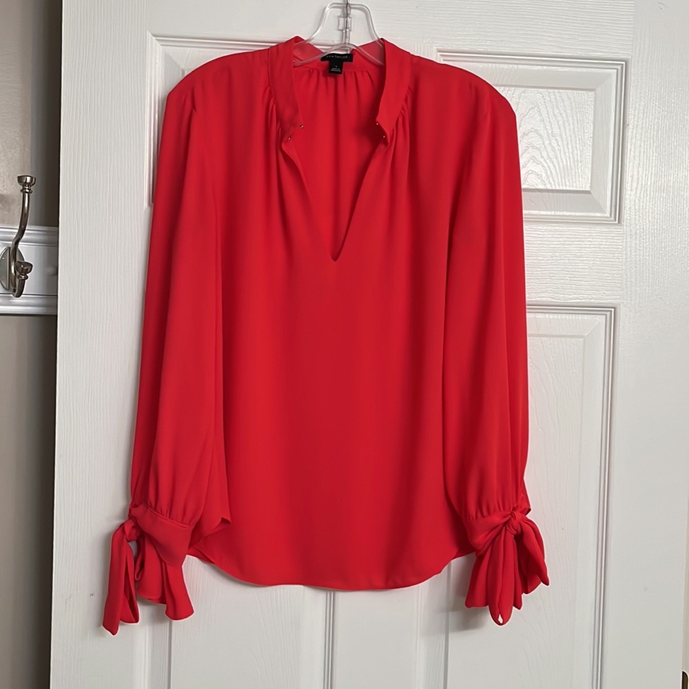 The color is a gorgeous “Coral” Ann Taylor blouse with bell sleeves and ties.